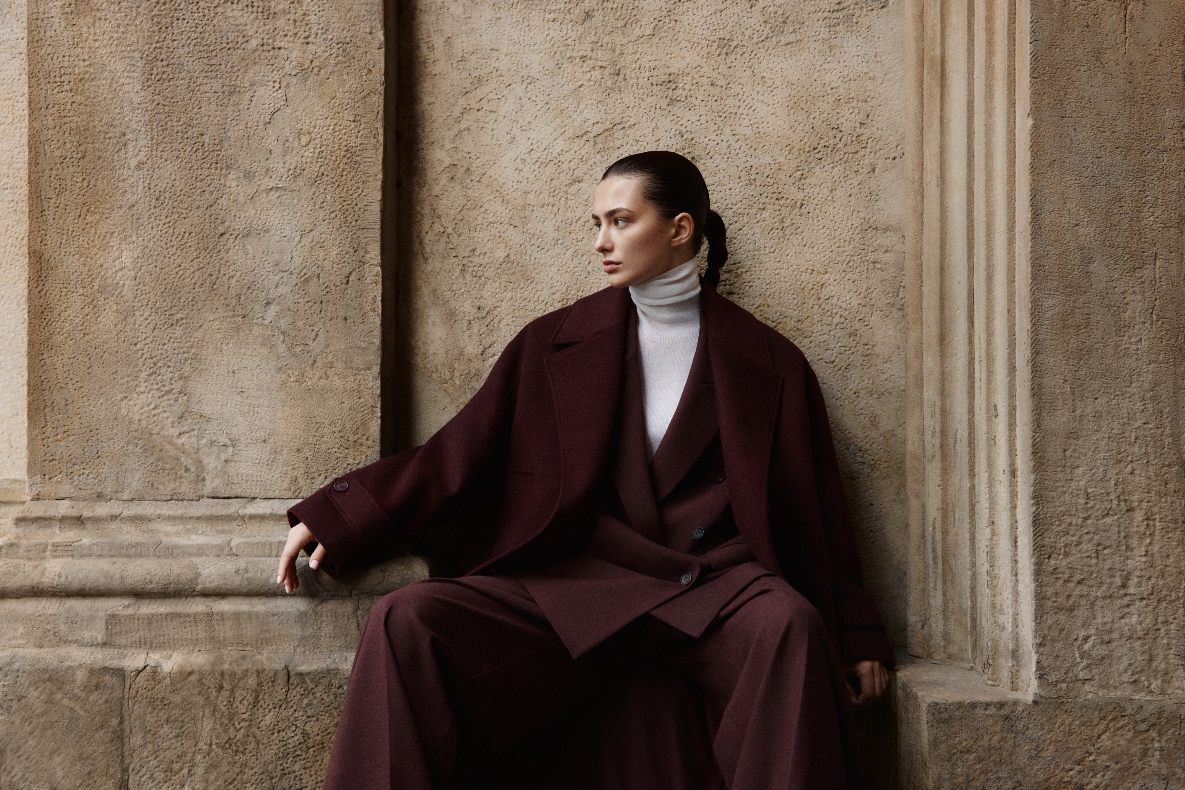 Editorial portrait in burgundy tailoring